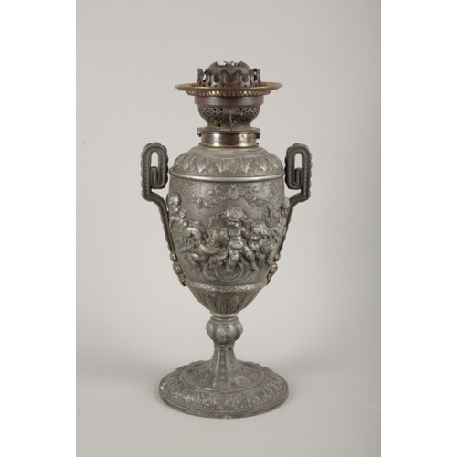 59 - A VICTORIAN PEWTER OIL LAMP IN ROCOCO STYLE BY THE 'CANDLE COMPANY... NEW BOND STREET'

decorated wi... 