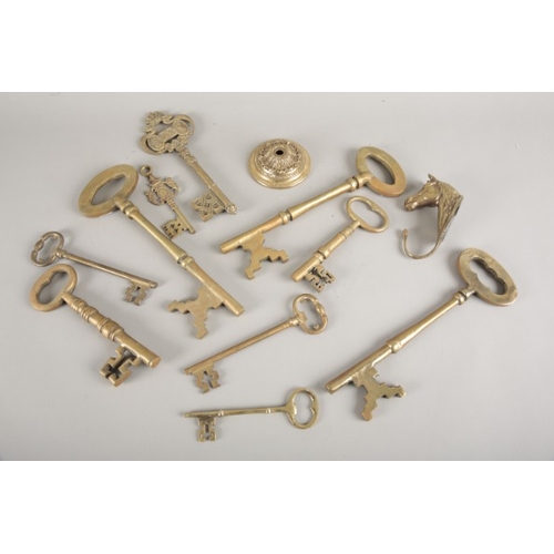 6 - A COLLECTION OF TEN BRASS KEYS

the largest 34cm long x 11cm; together with a horse head hook; and a... 