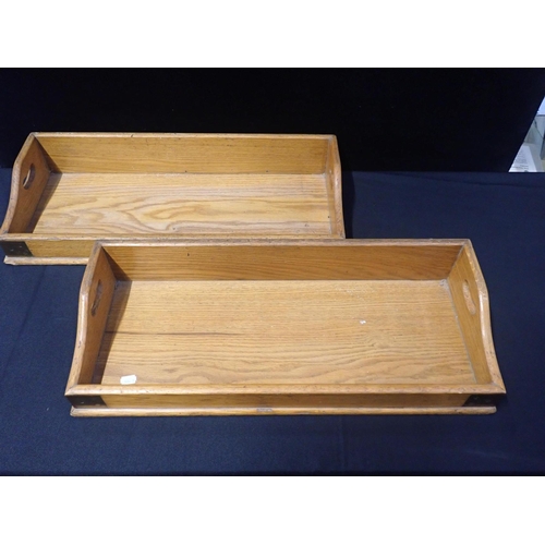 12 - A PAIR OF EARLY 20th CENTURY BRASS-BOUND LIGHT OAK BOOK TROUGHS

with pierced handles, each 28 x 66c... 