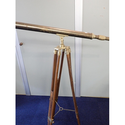 141 - A BRASS TELESCOPE AND TRIPOD

(a/f)