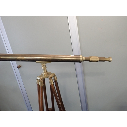 141 - A BRASS TELESCOPE AND TRIPOD

(a/f)