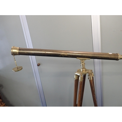 141 - A BRASS TELESCOPE AND TRIPOD

(a/f)