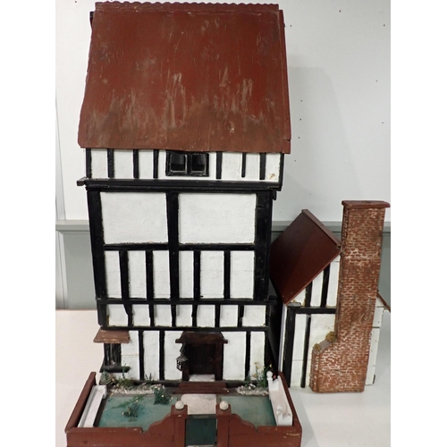 159 - A LARGE1920s TIMBER-FRAMED DOLL'S HOUSE; 'THE HALL'

home-built, the interior with panelling, moulde... 