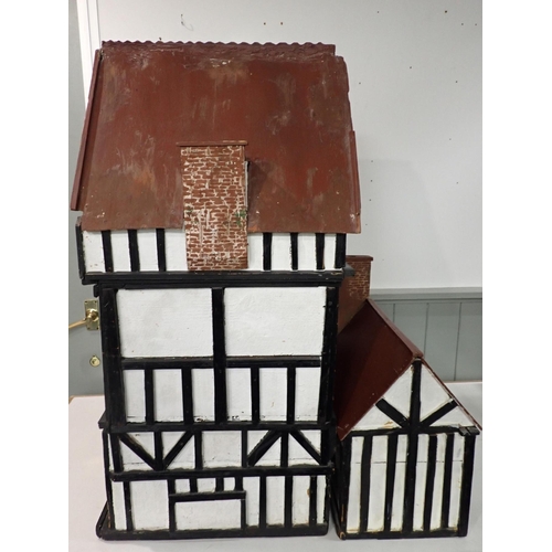 159 - A LARGE1920s TIMBER-FRAMED DOLL'S HOUSE; 'THE HALL'

home-built, the interior with panelling, moulde... 