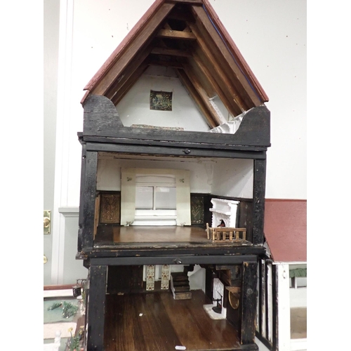 159 - A LARGE1920s TIMBER-FRAMED DOLL'S HOUSE; 'THE HALL'

home-built, the interior with panelling, moulde... 