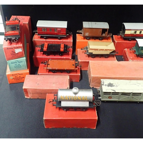 205 - A COLLECTION OF BOXED HORNBY 0 GAUGE GOODS WAGONS AND COACHES

mostly played with