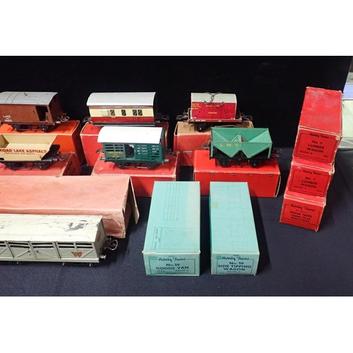 205 - A COLLECTION OF BOXED HORNBY 0 GAUGE GOODS WAGONS AND COACHES

mostly played with