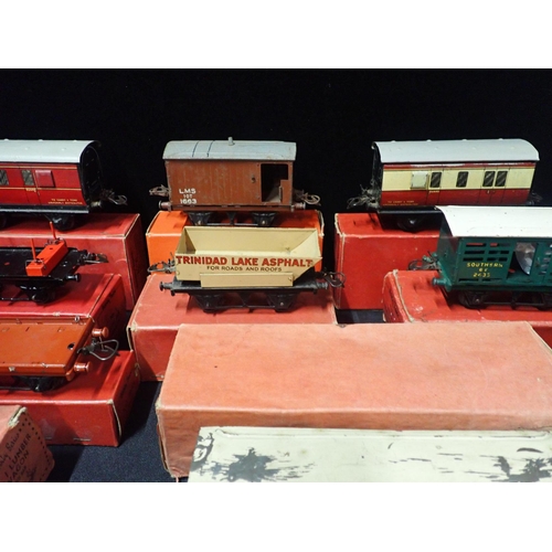 205 - A COLLECTION OF BOXED HORNBY 0 GAUGE GOODS WAGONS AND COACHES

mostly played with