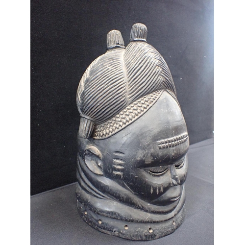 234 - A MENDE OR TEMNE BUNDU HELMET MASK

with ridged coiffure with double top knots 35cm high (cracked)