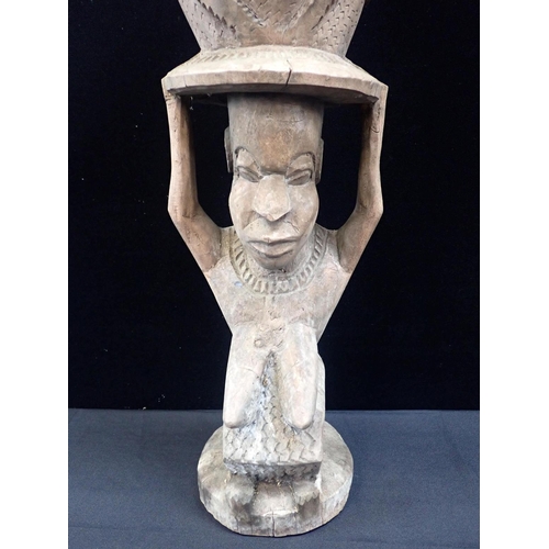 235 - AN AFRICAN PEG DRUM WITH FIGURAL SUPPORT

the drum carved with three faces, possibly Baule, 84cm hig... 