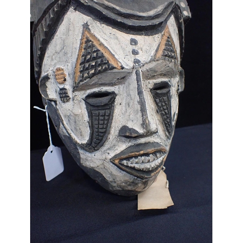 237 - AN IBO (IGBO) MAIDEN SPIRIT MASK

with white face and raised leaf crest 36cm high (old label attache... 