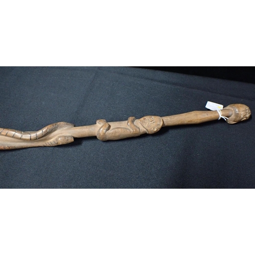 273 - AN AFRICAN STAFF OR WALKING STICK CARVED WITH SNAKES AND CLIMBING FIGURES

with head terminal 117cm ... 