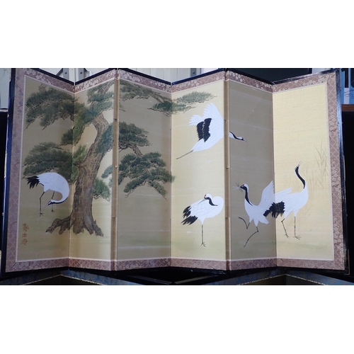 346 - A JAPANESE FABRIC SIX FOLD TABLE SCREEN

painted with cranes amongst trees, ebonised wood framing, e... 