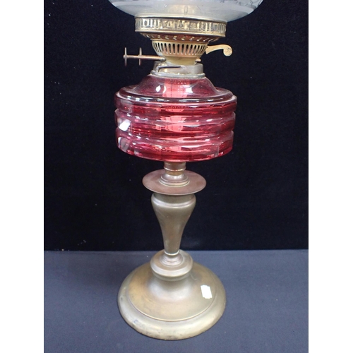 36 - A VICTORIAN OIL LAMP WITH FACETED CRANBERRY GLASS FONT

and etched beehive-shape shade