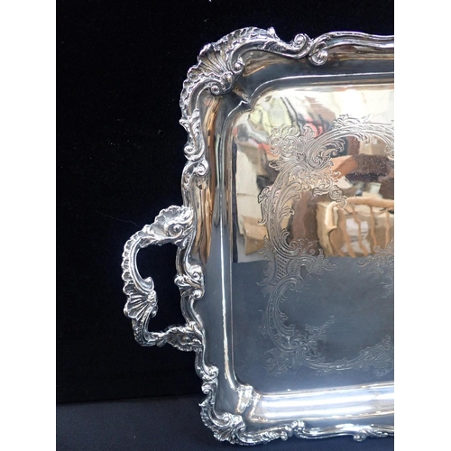 362 - A VICTORIAN SILVER PLATED TWO HANDLED TRAY

with raised Rococo border and engraved centre 65 x 43cm,... 