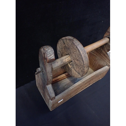 37 - A 19th CENTURY RUSTIC WOODEN AND IRON WINDER

the iron spindle 54cm long, the box 37cm wide