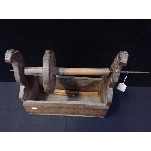 37 - A 19th CENTURY RUSTIC WOODEN AND IRON WINDER

the iron spindle 54cm long, the box 37cm wide