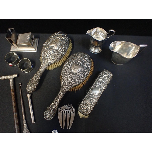 402 - A QUANTITY OF SILVER AND WHITE METAL WARE

including hairbrushes, a cigar cutter/match holder, a par... 