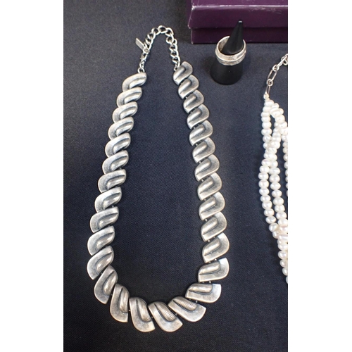 410 - A MODERNIST WHITE METAL NECKLACE BY KIEN

a modernist white metal ring, and a three row pearl choker... 