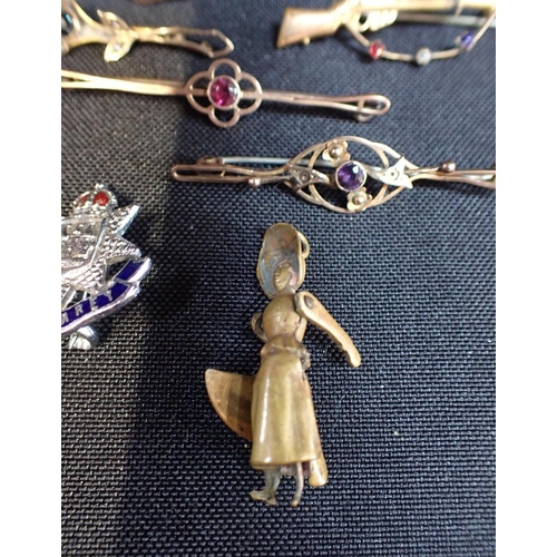 424 - A COLLECTION OF BAR BROOCHES

together with a cross pendant and novelty Victorian lady pendant