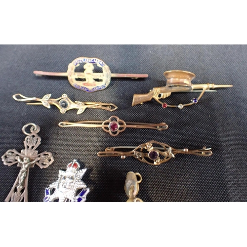 424 - A COLLECTION OF BAR BROOCHES

together with a cross pendant and novelty Victorian lady pendant