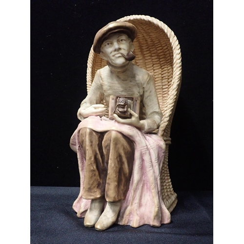 43 - AN AUSTRIAN 'AMPHORA' POTTERY BEACH PHOTOGRAPHER

seated in his basket chair 31cm high, a Lancaster ... 