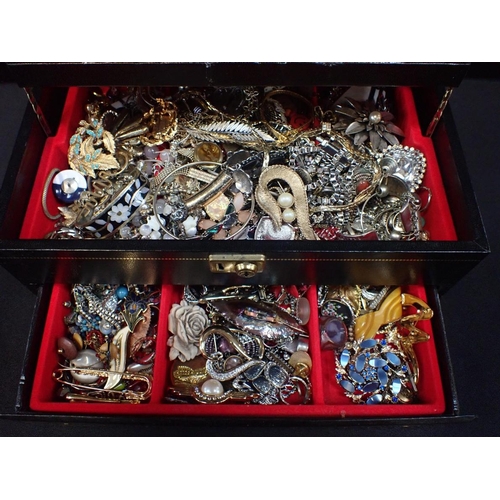 432 - A COLLECTION OF COSTUME JEWELLERY

brooches etc, contained in a three-tier jewellery box