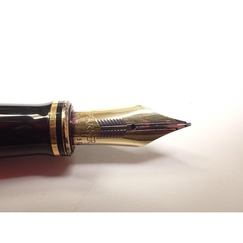 456 - A PARKER DUOFOLD INTERNATIONAL FOUNTAIN PEN

black body with gilt rings and 18k gold 750 marked two-... 