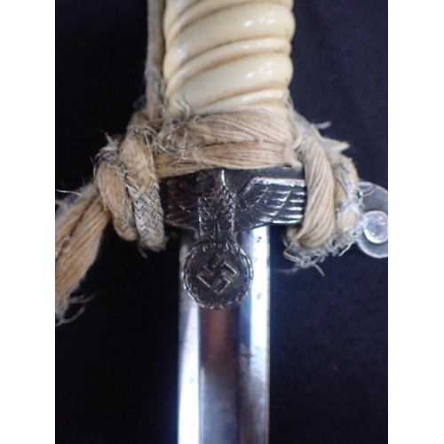 527 - A THIRD REICH OFFICER'S DAGGER

in scabbard, the blade marked 'P.D. LUNESCHLOSS', with braided tasse... 