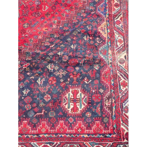 737 - A LARGE QASHQAI SHIRAZ CARPET

red ground 235 x 325cm