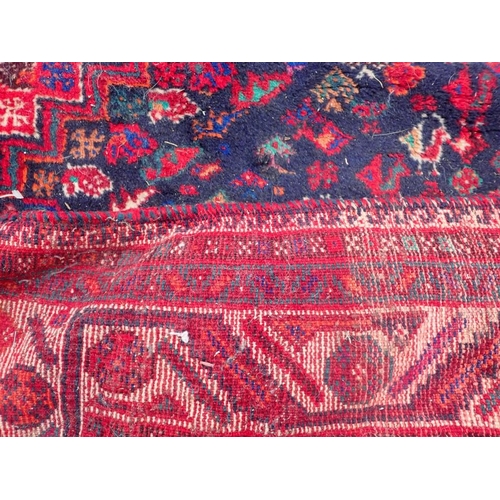 737 - A LARGE QASHQAI SHIRAZ CARPET

red ground 235 x 325cm