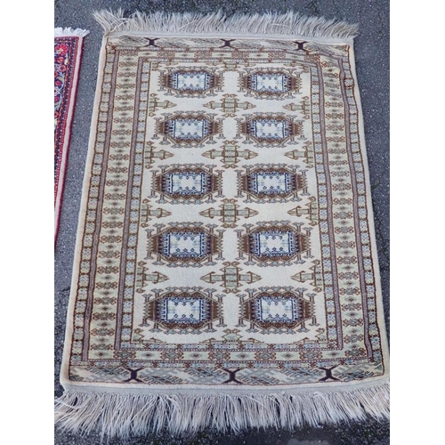 738 - A SMALL HAND KNOTTED PERSIAN RUG

in bright colours 72 x 105cm plus fringes, and another 84 x 107cm ... 