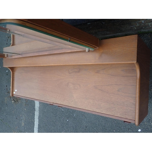 753 - A MID-CENTURY MEREDEW TEAK DRESSING TABLE

of long, low form, with four drawers and shaped framed tr... 