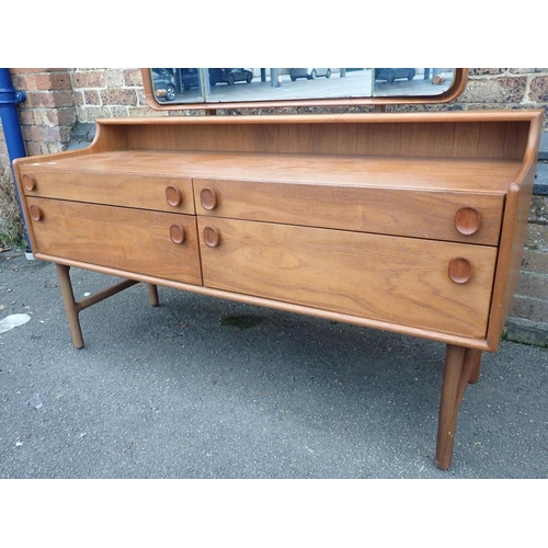 753 - A MID-CENTURY MEREDEW TEAK DRESSING TABLE

of long, low form, with four drawers and shaped framed tr... 