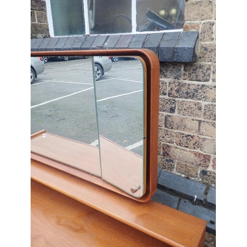 753 - A MID-CENTURY MEREDEW TEAK DRESSING TABLE

of long, low form, with four drawers and shaped framed tr... 