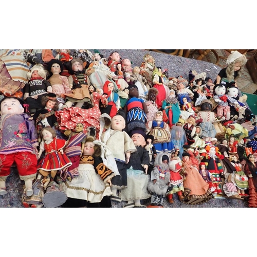 77 - A LARGE COLLECTION OF WORLD COSTUME DOLLS

including some older, one with a wax head, some bisque he... 