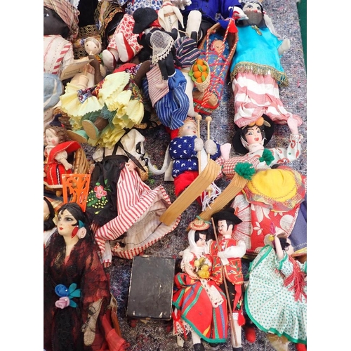 77 - A LARGE COLLECTION OF WORLD COSTUME DOLLS

including some older, one with a wax head, some bisque he... 