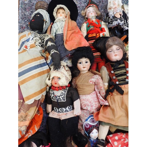 77 - A LARGE COLLECTION OF WORLD COSTUME DOLLS

including some older, one with a wax head, some bisque he... 