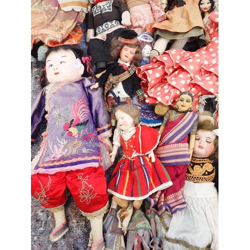 77 - A LARGE COLLECTION OF WORLD COSTUME DOLLS

including some older, one with a wax head, some bisque he... 