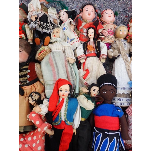 77 - A LARGE COLLECTION OF WORLD COSTUME DOLLS

including some older, one with a wax head, some bisque he... 