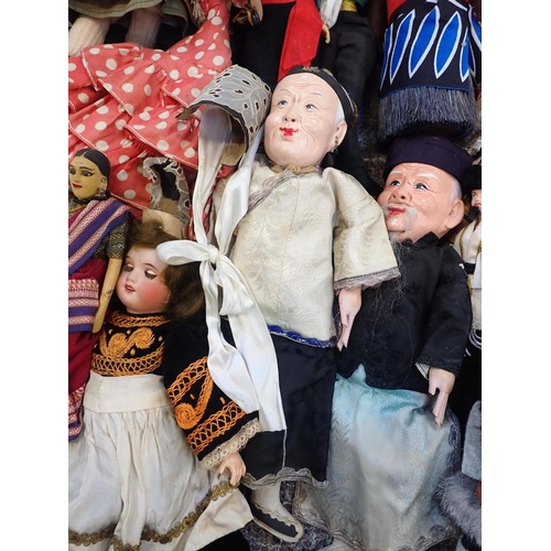 77 - A LARGE COLLECTION OF WORLD COSTUME DOLLS

including some older, one with a wax head, some bisque he... 