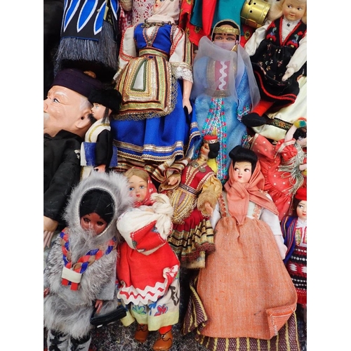 77 - A LARGE COLLECTION OF WORLD COSTUME DOLLS

including some older, one with a wax head, some bisque he... 