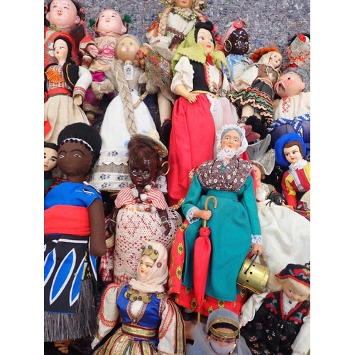 77 - A LARGE COLLECTION OF WORLD COSTUME DOLLS

including some older, one with a wax head, some bisque he... 