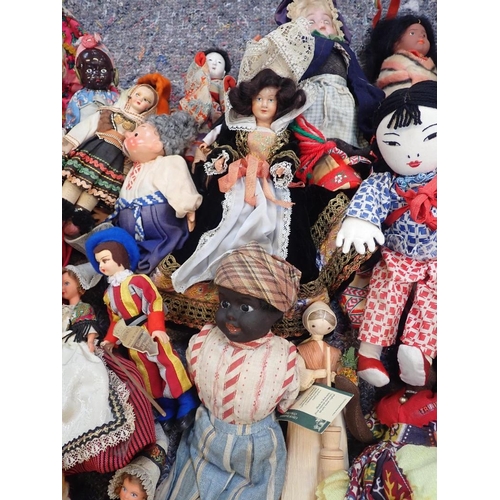 77 - A LARGE COLLECTION OF WORLD COSTUME DOLLS

including some older, one with a wax head, some bisque he... 