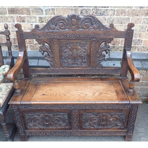 773 - A VICTORIAN CARVED OAK HALL BENCH

with lift-up seat 104cm wide (small scroll missing). a similar oa... 