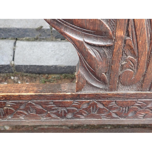 773 - A VICTORIAN CARVED OAK HALL BENCH

with lift-up seat 104cm wide (small scroll missing). a similar oa... 