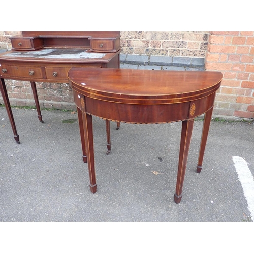 776 - AN EDWRDIAN MAHOGANY BOWFRONT DESK

on tapering legs, with an arrangement of four drawers, and inset... 