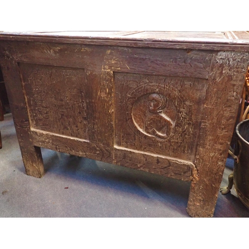 790 - A PANELLED OAK COFFER, WITH CARVED FRONT

and one back panel carved with a 'Romayne' type head 98cm ... 