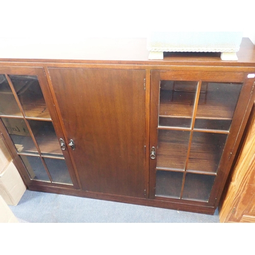 805 - A 1930s MAHOGANY BOOKCASE

with glazed doors flanking a central plain door 138cm wide, and a 'Spinne... 