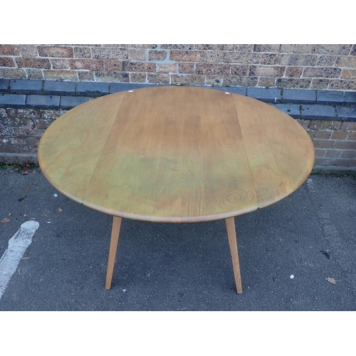 819 - ERCOL: A BLOND ELM DROP-LEAF DINING TABLE

125 x 114cm (open), and a narrow Ercol elm plate rack 43c... 